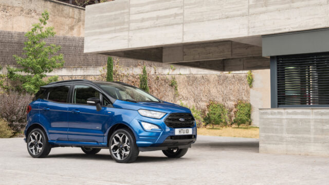 Blue Ford EcoSport Parked Against Modern Building Background