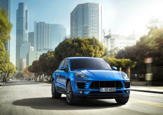 Blue Porsche Macan Driving Through Urban Cityscape Porsche Macan Wallpapers