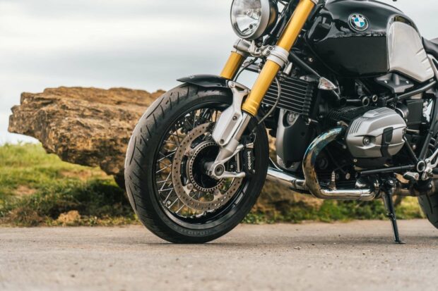 A close up of a Bmw R Nine T motorcycle front wheel and engine details parked outdoors, HD Desktop Wallpaper