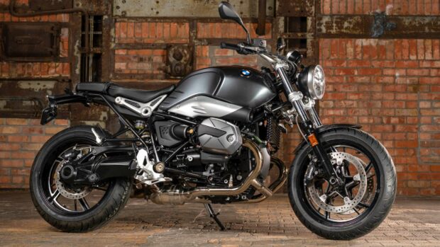 A BMW R Nine T motorcycle is parked indoors with a brick wall background, HD Desktop Wallpaper