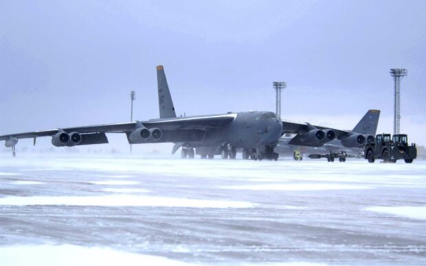 A Boeing B 52 bomber is parked on a snow covered runway during winter, 2K Desktop Wallpaper
