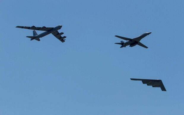 A formation flight shows the Boeing B 52 along with other aircraft against a clear blue sky, 2K Desktop Wallpaper