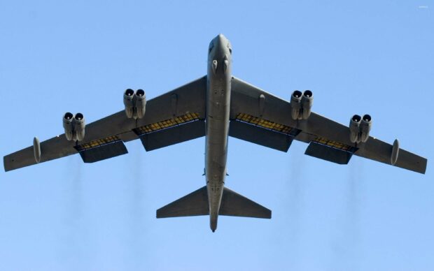 A Boeing B 52 is flying with its landing gear retracted against a clear blue sky, 2K PC Wallpaper