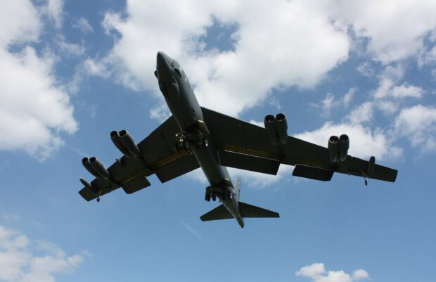 A Boeing B 52 is flying with its landing gear down against a backdrop of clouds, HD Desktop Wallpaper