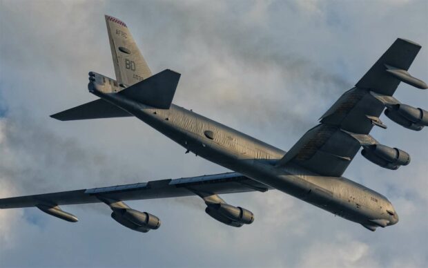 A Boeing B 52 is flying against a cloudy sky with visible details on the aircraft, HD Desktop Wallpaper