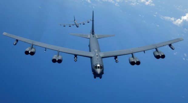A Boeing B 52 flies in formation over the ocean under a clear blue sky, HD Desktop Wallpaper