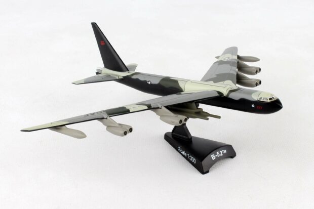 A detailed model of a Boeing B 52 displayed on a stand with camouflage paint, 2K Desktop Wallpaper