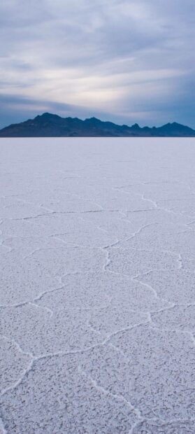 The Bolivia salt flat stretches under a cloudy sky with distant mountains on the horizon, HD Phone Wallpaper