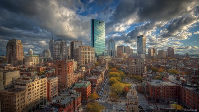 Boston Skyline Wide Screen Desktop Wallpaper, Bustling Urban Landscape Of Boston With Skyscrapers And Historic Buildings Under A Dramatic Sky