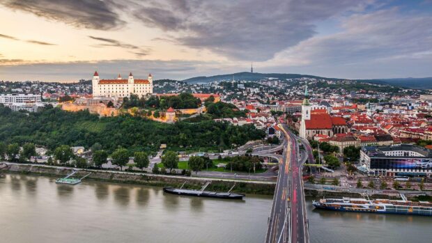 Bratislava Wallpapers show the city with a castle and bridges at sunset, 2K Desktop Wallpaper