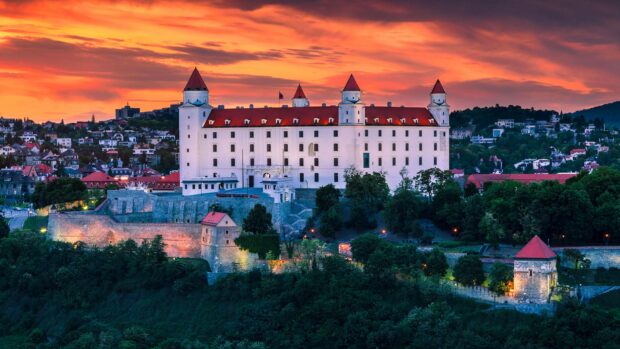 The Bratislava castle stands tall during the vibrant sunset with colorful skies, HD Desktop Wallpaper