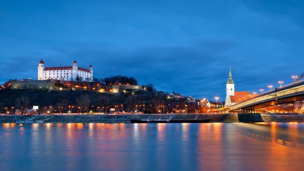The Bratislava cityscape features a castle, river, and illuminated bridge under a blue twilight sky, HD Desktop Wallpaper