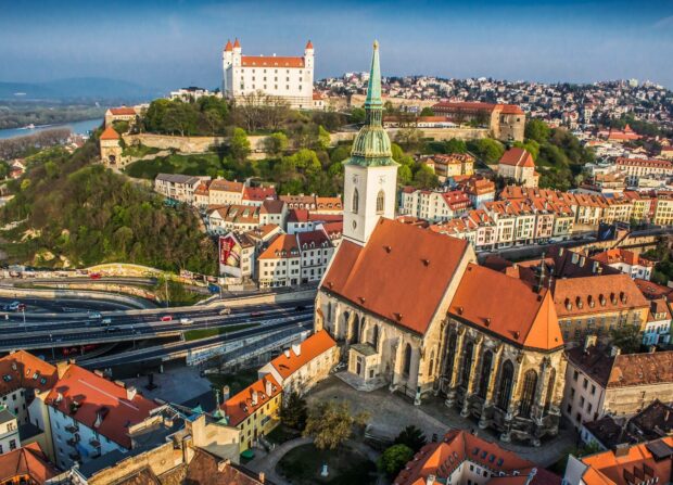 The Bratislava cityscape features the historic castle and old town buildings under a clear sky, HD Desktop Wallpaper