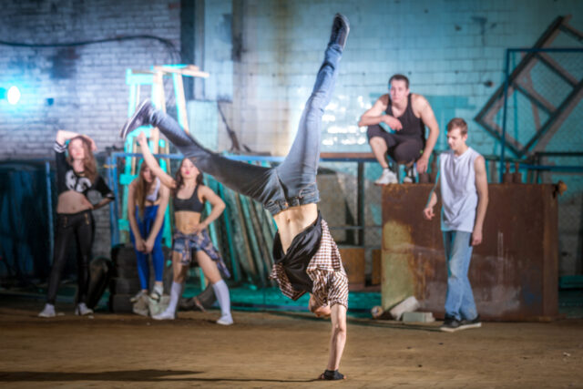 Breakdancing Crew In Action Energetic Street Dance Wallpaper