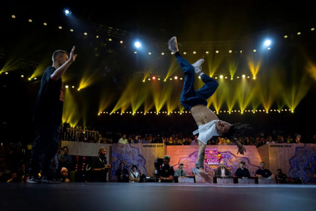 Breakdancing Performance On Stage At A Vibrant Dance Competition