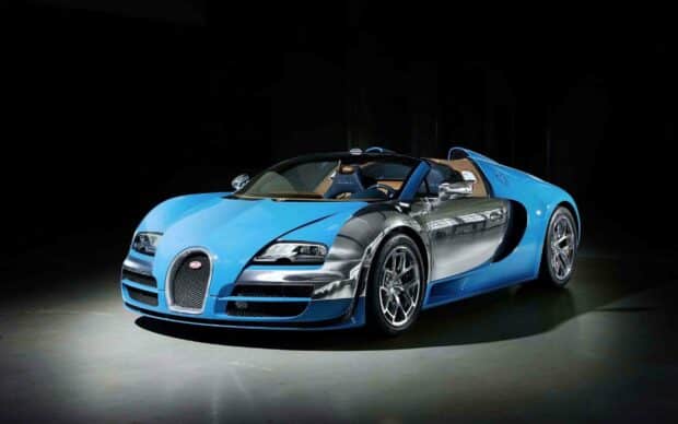 A blue and silver Bugatti Veyron is displayed in a dark room, 2K Desktop Wallpaper