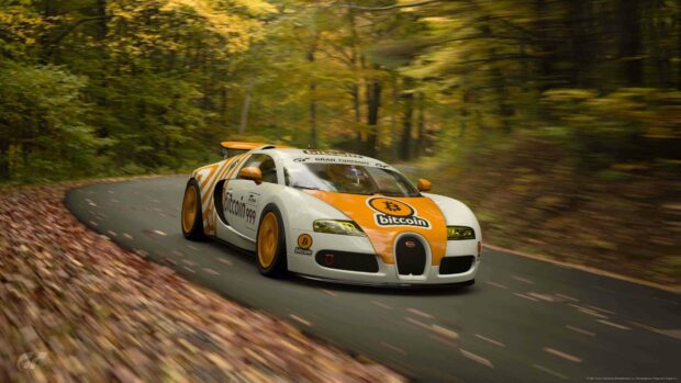 A Bugatti Veyron with a Bitcoin decal speeds along a forest road in autumn, 4K Desktop Wallpaper
