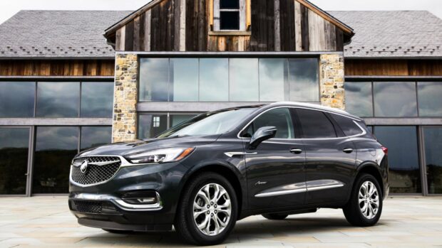 A black Buick Enclave parked in front of a modern house with large windows, 4K Desktop Wallpaper