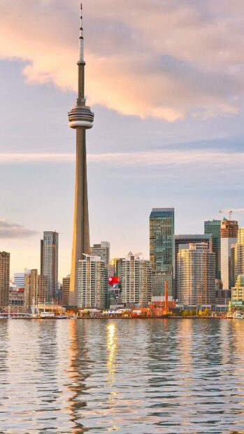 The CN Tower in Canada stands tall above the city skyline at sunset, HD Mobile Wallpaper