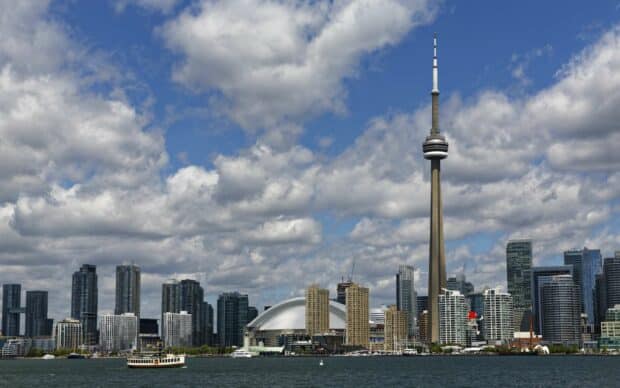 The CN Tower stands tall among Toronto's city skyline and waterfront, 2K Desktop Wallpaper