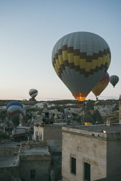 Colorful hot air balloons float over the rocky landscape of Cappadocia at sunrise, HD Mobile Wallpaper