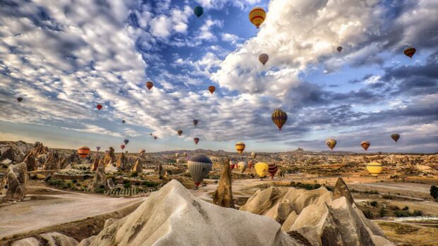 Colorful hot air balloons float over the unique rock formations in Cappadocia, Turkey, HD Desktop Wallpaper