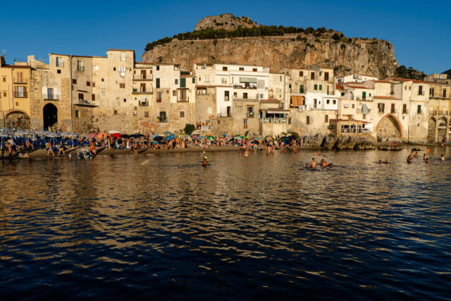 Cefalu Beachfront Serenity In Golden Sunlight Wallpaper