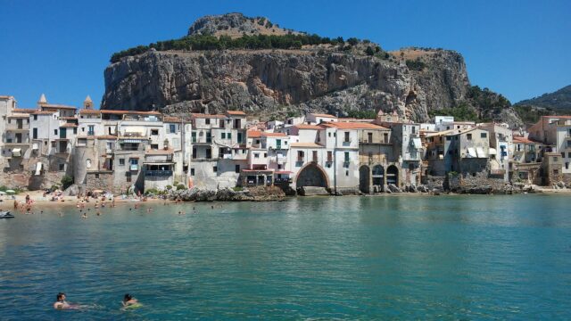 Cefalu Coastal Town And Rocky Cliffs Scenic Wallpaper
