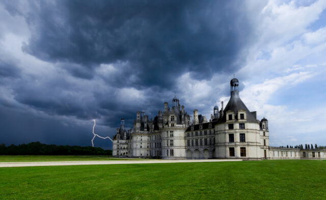 Chateau De Chambord With Dramatic Stormy Sky And Lightning Background Wallpaper