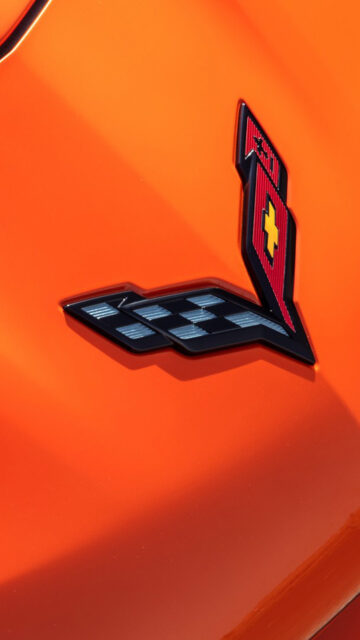 Chevrolet Corvette Logo Close Up On Vibrant Orange Background For Wallpapers