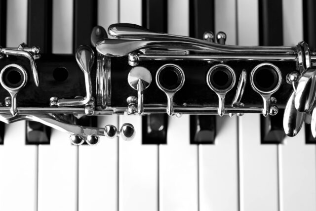 Clarinet On Piano Keys Black And White Wallpaper