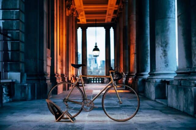 Classic Colnago Road Bike Wallpaper in Historic Urban Setting with Warm Lighting