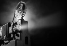 Classic Film Projector Illuminates Lumiere Brothers Era Wallpaper