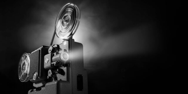 Classic Film Projector Illuminates Lumiere Brothers Era Wallpaper