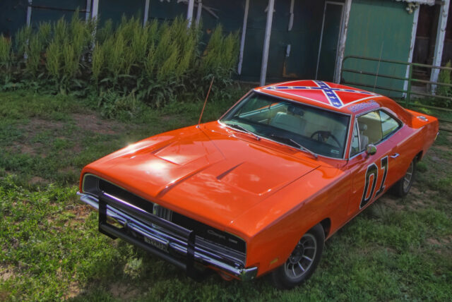 Classic General Lee Car Wallpaper Featuring Bright Orange Dodge Charger on Grass