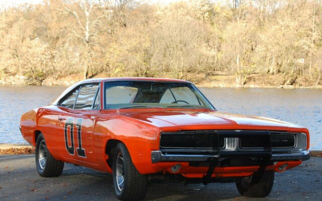 Classic General Lee Dodge Charger Car in Scenic Outdoor Setting Wallpaper