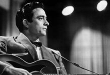 Classic Johnny Cash Guitar Performance Black And White Wallpaper