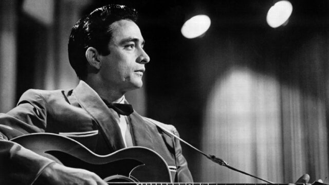 Classic Johnny Cash Guitar Performance Black And White Wallpaper
