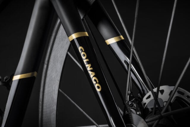 Close up of black and gold Colnago bicycle fork with wheel spokes Colnago wallpapers