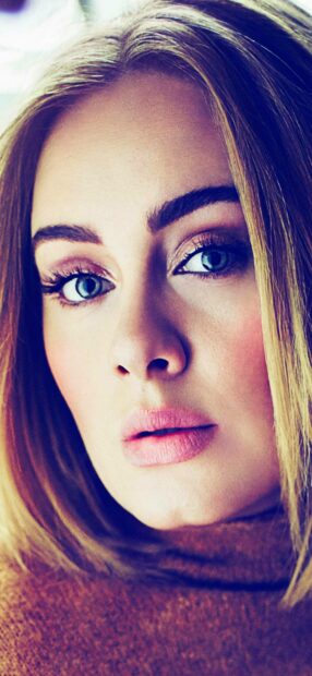 A close up portrait of Adele showing her expressive blue eyes and soft features, HD Phone Wallpaper
