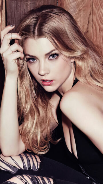 Close Up Portrait Of Natalie Dormer, A Striking Close Up Portrait Of Natalie Dormer With Blonde Hair And Blue Eyes Sitting Against A Wooden Background, 4K Phone Wallpaper