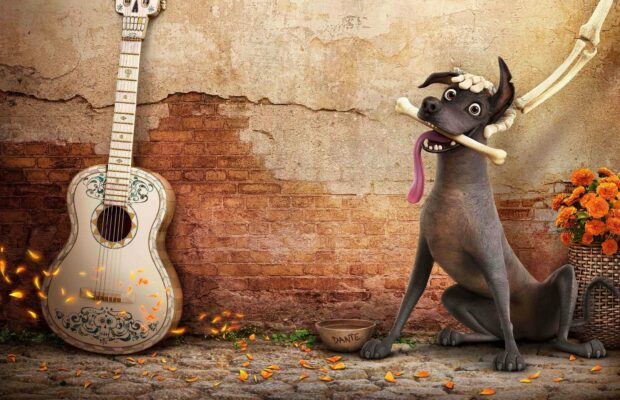 A lively Coco cartoon character sits beside a decorated guitar and flowers with a playful expression, 2K Desktop Wallpaper