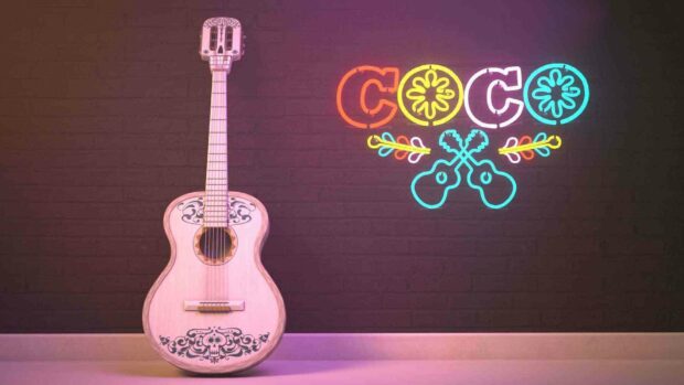 A decorative guitar with skull patterns stands next to a colorful Coco neon sign on a brick wall, HD Desktop Wallpaper
