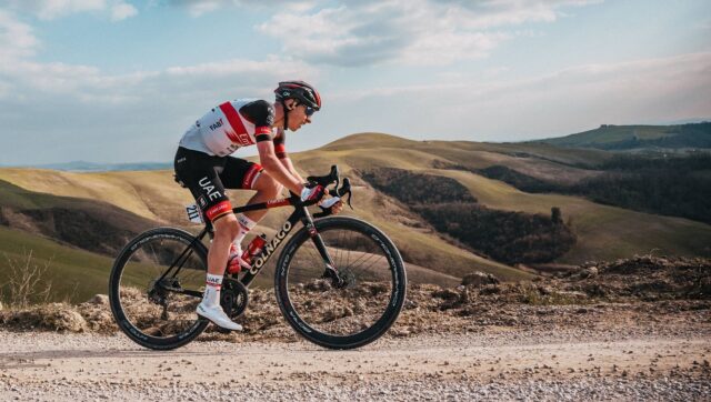 Colnago Wallpapers Professional Cyclist Riding on Rough Terrain in Scenic Hills