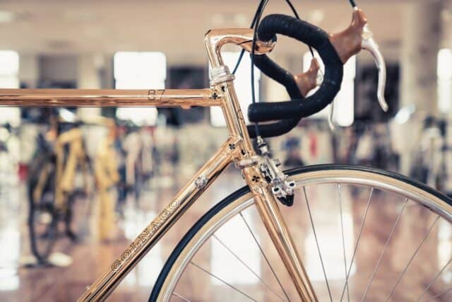 Colnago road bike close up with shiny metallic frame in showroom perfect wallpaper