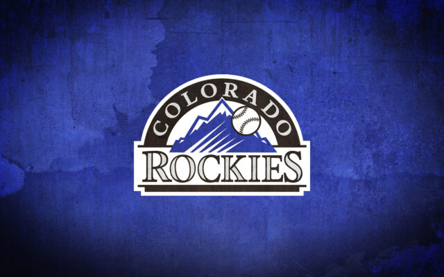 Colorado Rockies Logo on Blue Grunge Background Wallpaper for Fans