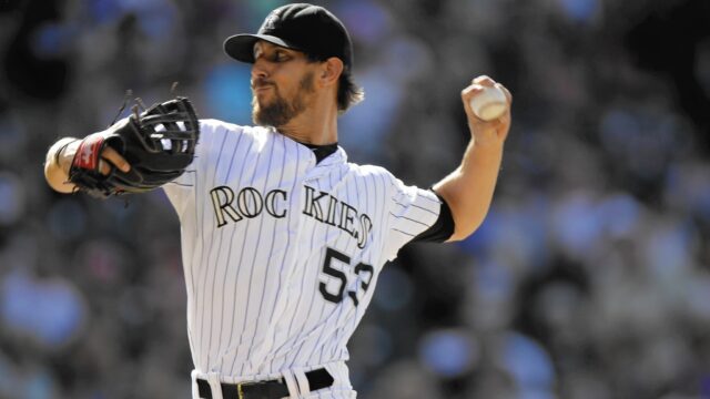 Colorado Rockies Pitcher in Action Throwing Baseball Game Wallpaper
