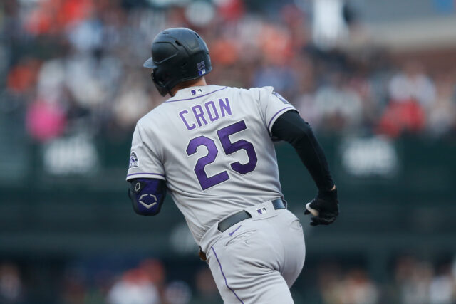 Colorado Rockies Player Cron Running on Baseball Field Wallpaper