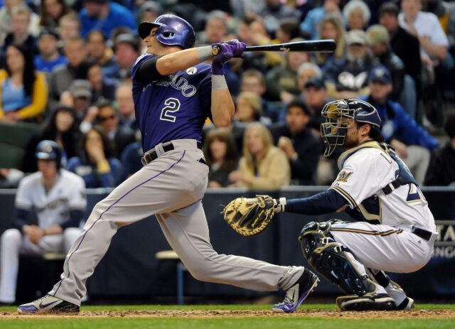 Colorado Rockies Player Hitting Baseball During Game Action Wallpaper