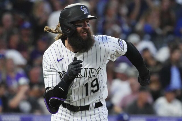 Colorado Rockies Player Running During Intense Baseball Game Action Wallpaper